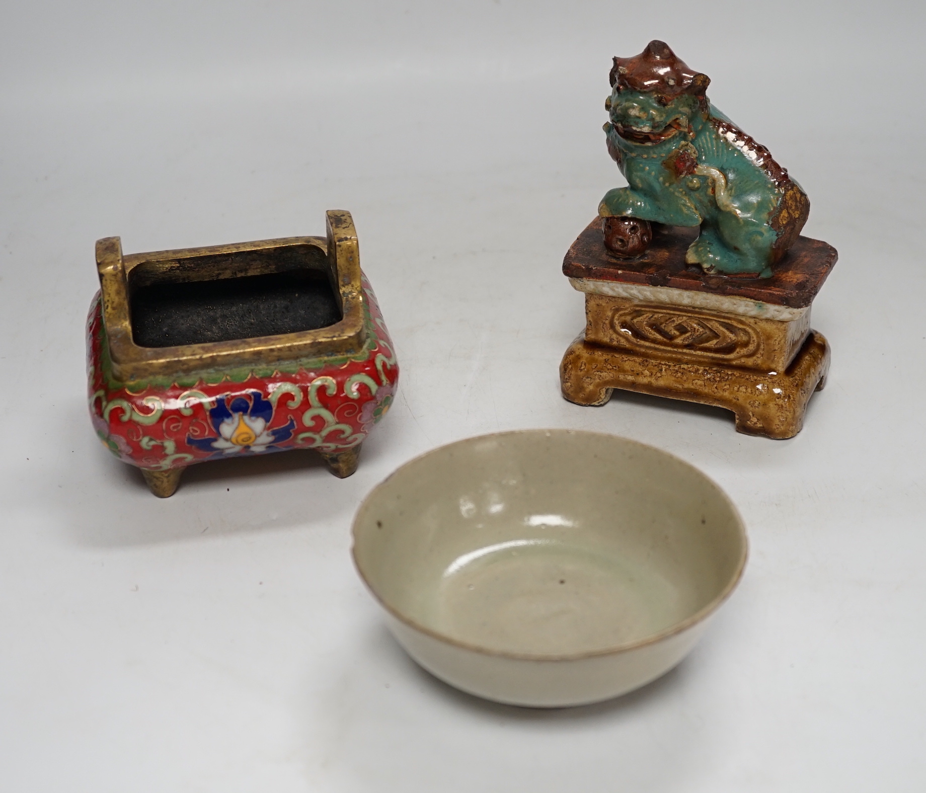A 19th century Chinese Shiwan figure of a lion-dog, a celadon glazed shallow bowl and a cloisonné enamel censer, tallest 14cm (3)